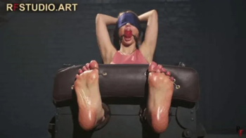 Guzel in Stocks - Oiled Bare Soles Tickled and Ballgagged by Two Ticklers (FULL HD MP4).webp