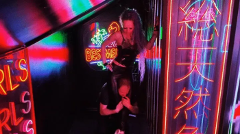 Standing headscissors in neon light.webp