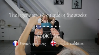 The legendary Veronique of -French Tickling- tickled in the stocks Part 2 ( French speaking with English subtitles ).webp
