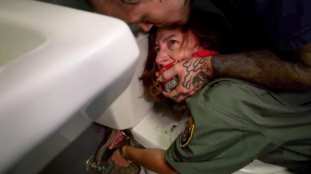 Changing of the Guard - Elise Graves and Heavy - Overpowered by an inmate, Officer Graves is gagged and bound in a humil.webp