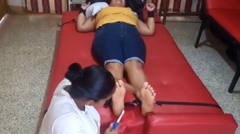 Eli provokes laughter by tickling Anyeli's feet!.webp