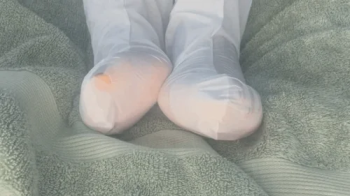 Ebony giantess puts on a foot mask for her feet.webp