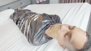 BABE AND BELLA CRUEL FARTING ON THE SLAVE TRAPPED IN PLASTIC WITH HIS MOUTH SEALED - CLIP 1.webp
