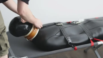 Twink strapped into the neoprene sack and edged relentlessly.webp