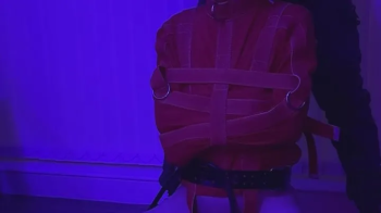 Straitjacket twink milked on the kneeler.webp