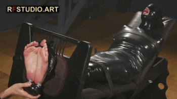 Brittany in Tight PVC Mummification Part 3 - Foot Tickling in Stocks (UHD 4K MP4).webp