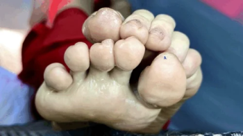 A very Tiny human being is placed on the soles of a Giantess' feet.webp