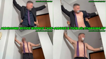 Handsome office worker tape-gagged and tickled standing up.webp