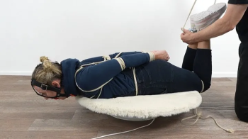 Hogtied in hoodie and overall.webp