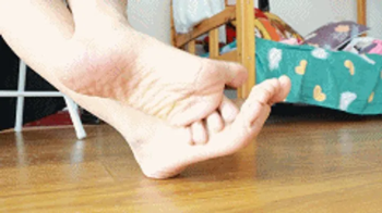 ANNA Asian model Feet Rubbing together.webp