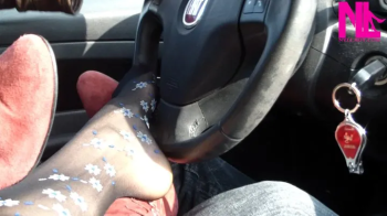 Footsie in the car in black floral pantyhose.webp