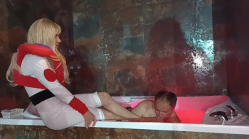 Foot domination by two superheroines in a bath.webp