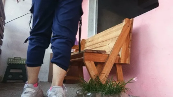 Woman smelling her socks and feet after arriving from training (7).webp