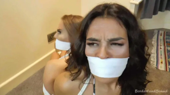 Emma & Latina in- Perils of the Dutch Amulet- Buxom CaveGirls Fall Afoul of the Utmost Villainy Up at BlueCheese Manse!.webp