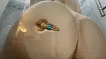 Unaware Giantess has a tiny in the shower makes him her loofah.webp