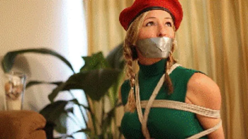 Amanda Kent as Cammy from Street Fighter captured, tied, gagged.webp