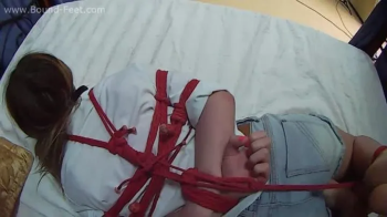 Ballgagged barefoot Bianca in white shirt and jeans shorts, hogtied with red hemp rope, is tickled by the man - POV vide.webp