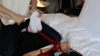A cute twin-tailed JK girl was tied to the bed and had her white-stockinged feet tickled with props.webp