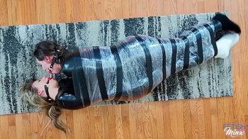 Cara and Minx - Friends Wrapped, Wriggling and Double Ball Gagged (MP4 Format).webp